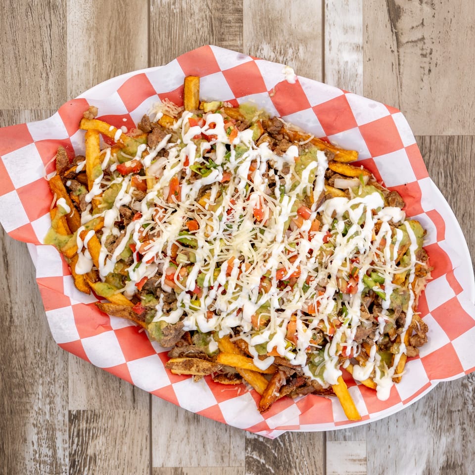 El Chapin's loaded fries with meat, guacamole, sour cream, pico de gallo, and shredded cheese.