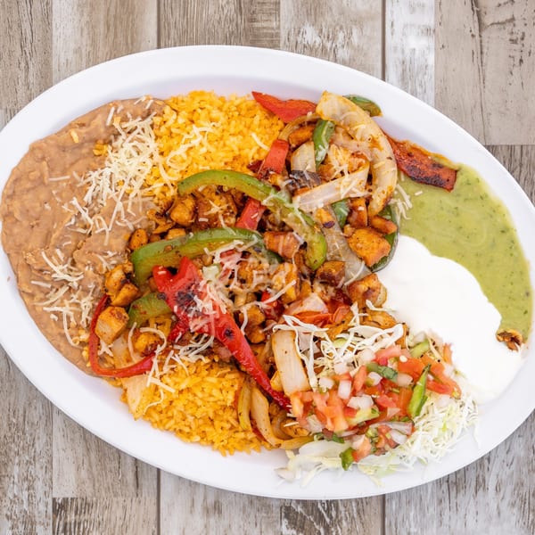 El Chapin's Mexican fajita plate with chicken, rice, beans, salsa verde, sour cream, and pico de gallo.