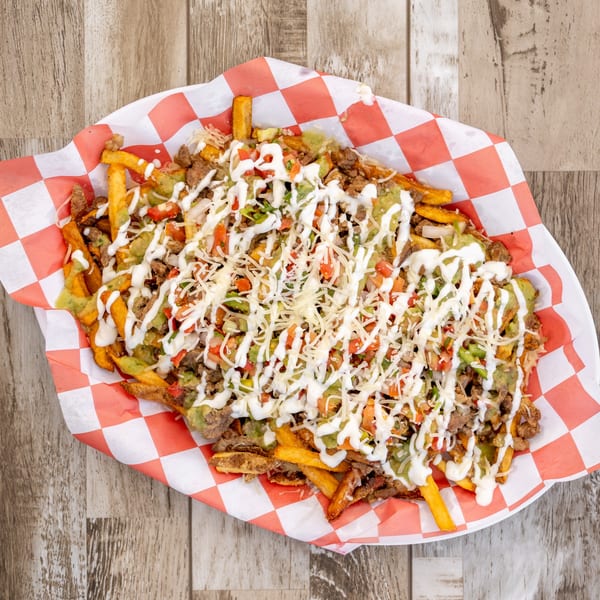 El Chapin's loaded carne asada fries with guacamole, sour cream, pico de gallo, and cheese.