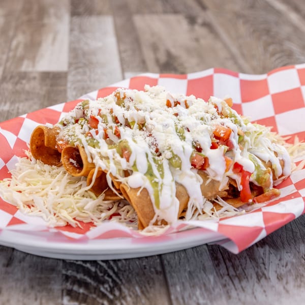Crispy taquitos topped with shredded cabbage, guacamole, sour cream, pico de gallo, and cotija cheese.