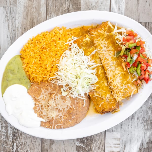 El Chapin's enchiladas with green sauce, rice, refried beans, guacamole, sour cream, and pico de gallo.
