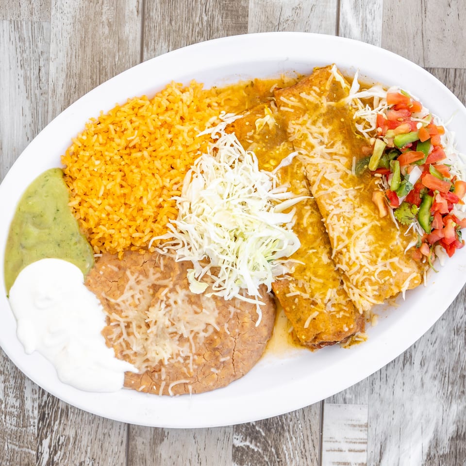 El Chapin's enchiladas with green sauce, rice, refried beans, guacamole, sour cream, and pico de gallo.
